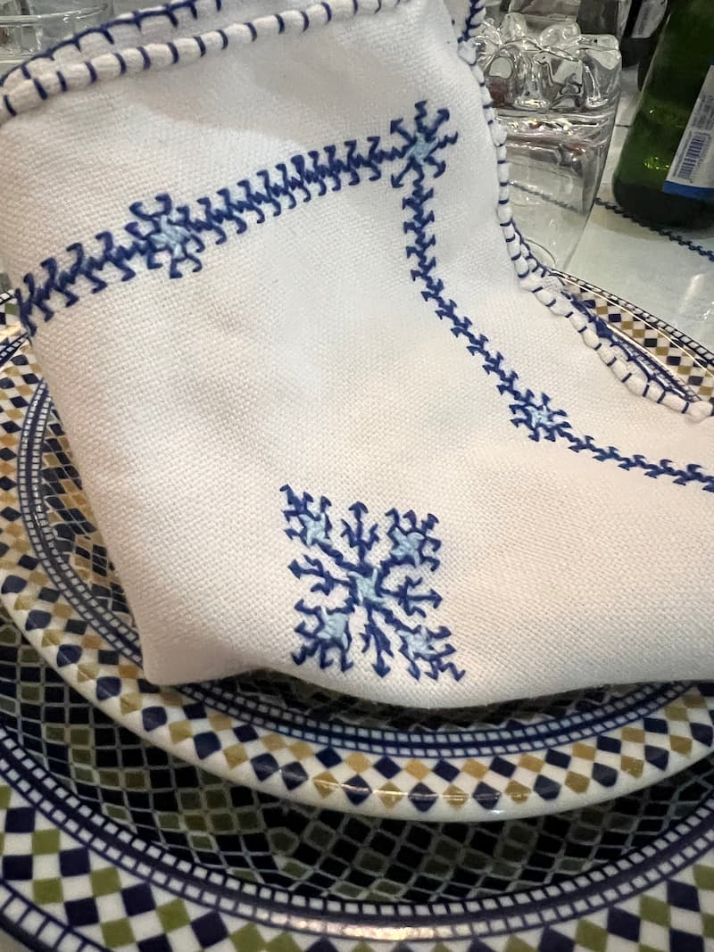embroidered napkin folded on plate